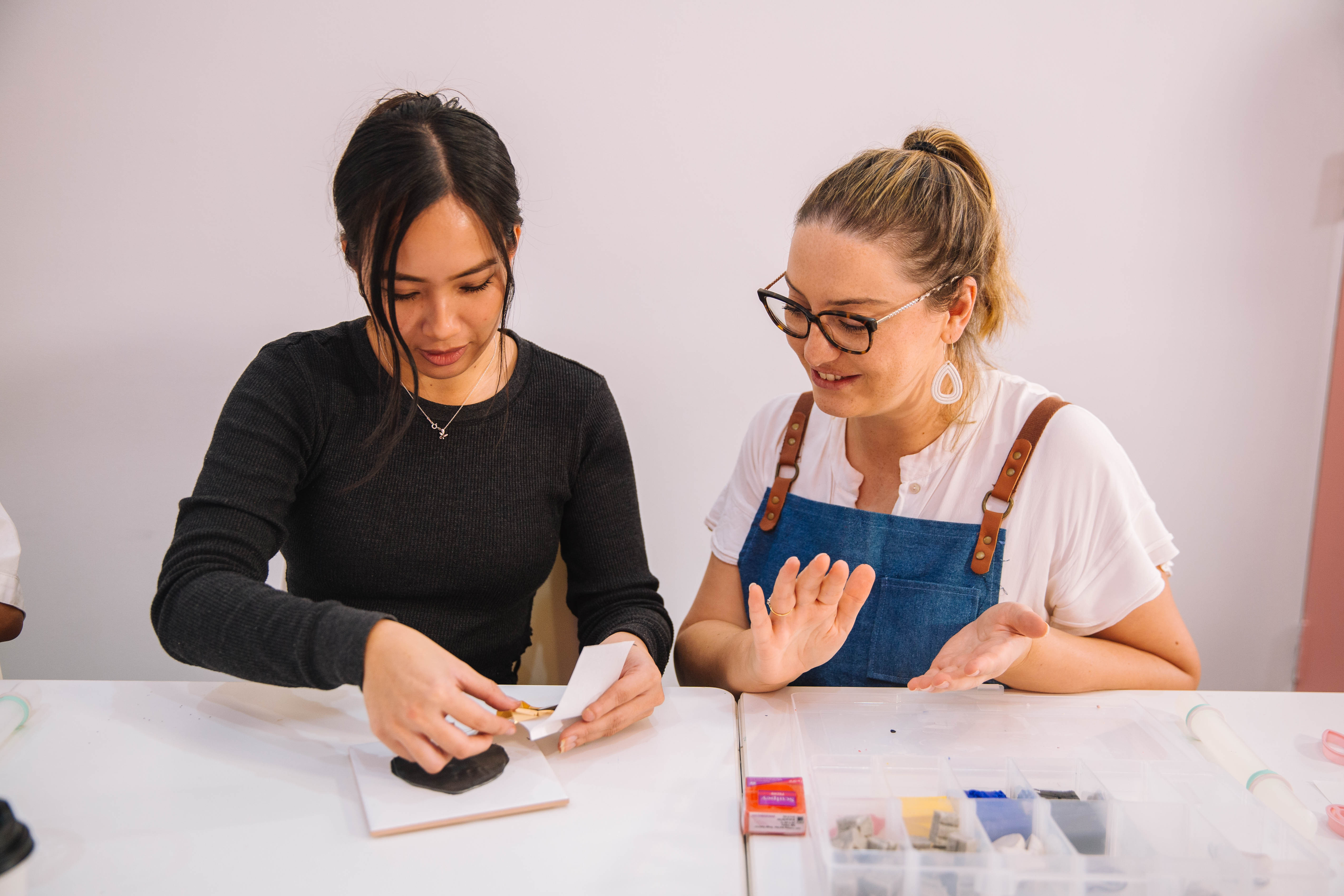 A teacher and student at a jewellery making class